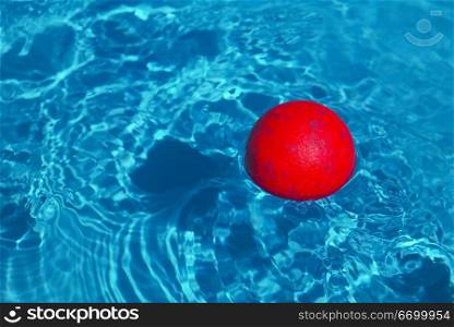 Red Ball Floating In A Swimming Pool