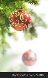 Red Balls on the Christmas Tree at the Defocused Lights Background