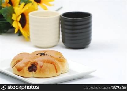 Red bean bread with tea and flower background