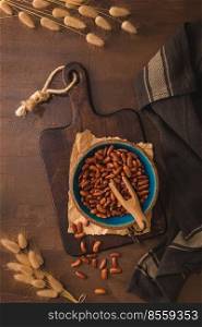 Red beans in a ceramic bowl on a rustic kitchen countertop.