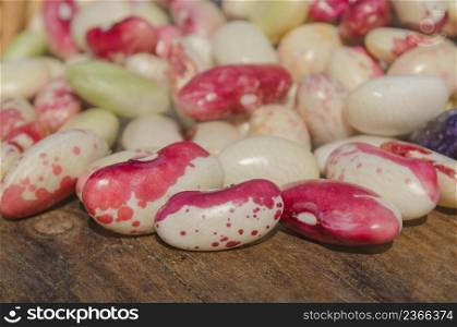 Red beans seeds on a wooden table. Lima beans in burlap bag