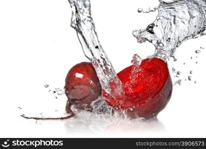 red beet with water splash isolated on white