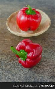 red bell pepper. red bell peppers on wooden table