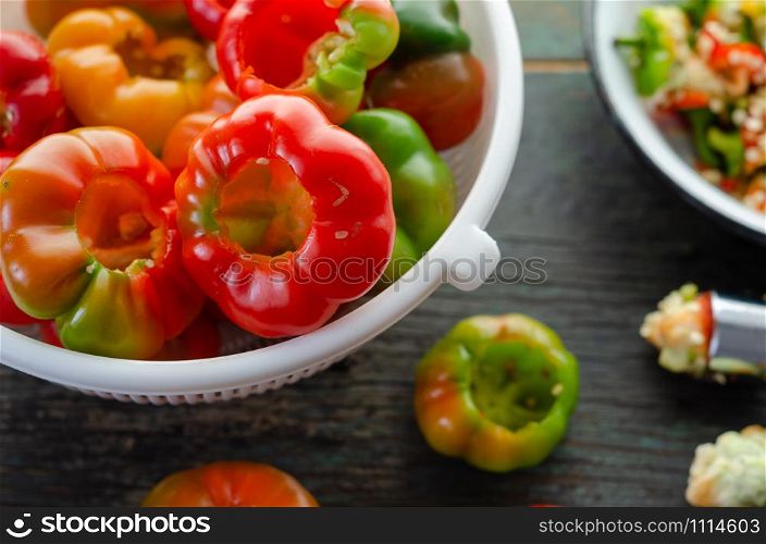 Red bell peppers on the wooden table.