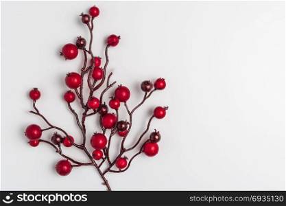 Red berries holly on white. Red Christmas ornaments frame. Image of Christmas. Top view with copy space.