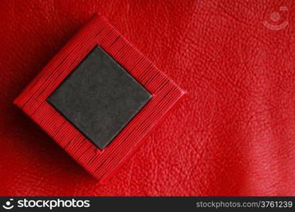 Red black rectangular ring jewellery box on leather background