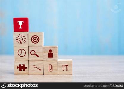 Red block with Trophy and business strategy icon on table background. Business Growth, Improvement, strategy, Successful, success, winner, cooperation and Mission complete Concepts
