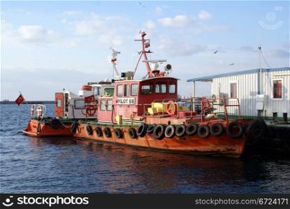 Red boat near sea shore in port Izmir, Turkey