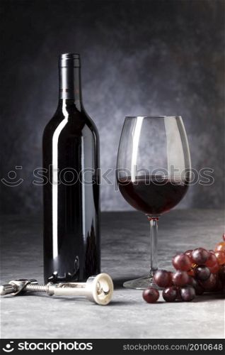 red bottle wine half empty glass
