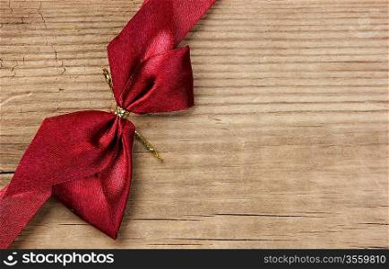 red bow and ribbon on the old wooden background