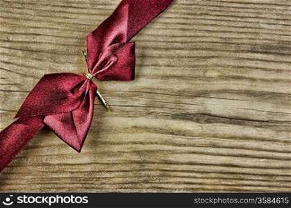 red bow and ribbon on the old wooden background