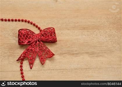 Red bow isolated on a wooden background