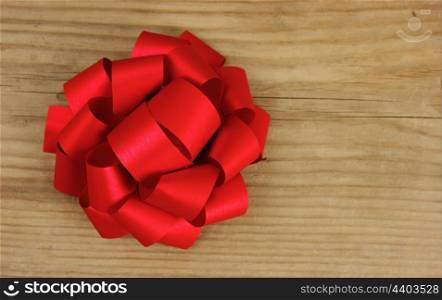 red bow on the old wooden background