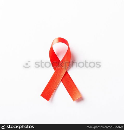 Red bow ribbon symbol HIV, AIDS cancer awareness with shadows, studio shot isolated on white background, Healthcare medicine concept, World AIDS Day