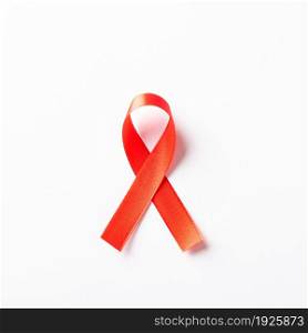 Red bow ribbon symbol HIV, AIDS cancer awareness with shadows, studio shot isolated on white background, Healthcare medicine concept, World AIDS Day