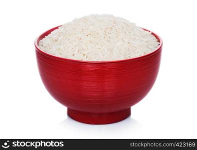 Red bowl of raw organic basmati rice on white background.