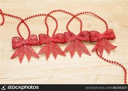 Red bows isolated on a wooden background