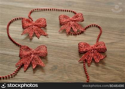 Red bows isolated on a wooden background