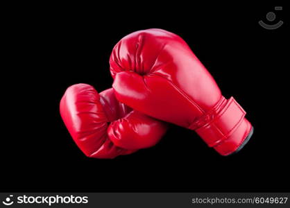 Red boxing gloves isolated on black