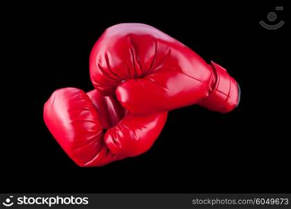Red boxing gloves isolated on black