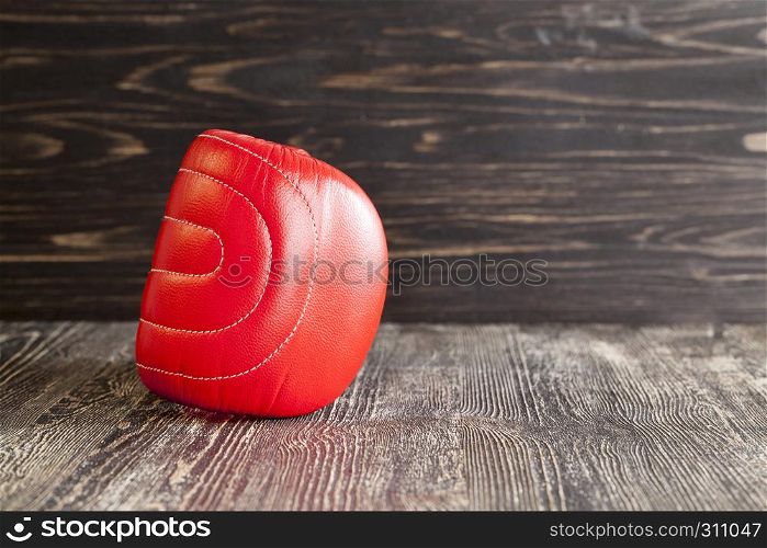 red boxing gloves on black board surface. boxing glove