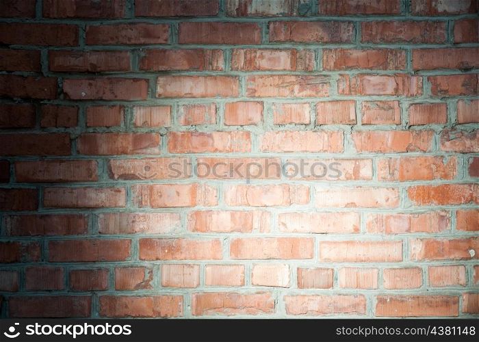 red brick wall and spot of light on, vignette
