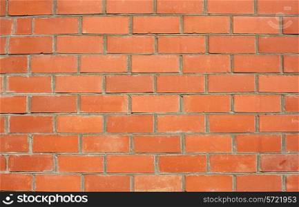 Red brick wall of the house, with lines of a laying of a solution