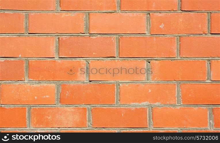 Red brick wall of the house, with lines of a laying of a solution