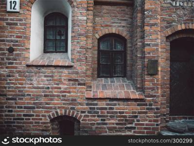 Red brickwall facade in ancient european style