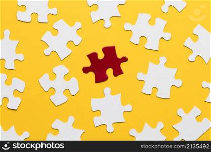 red bright puzzle among white against yellow backdrop