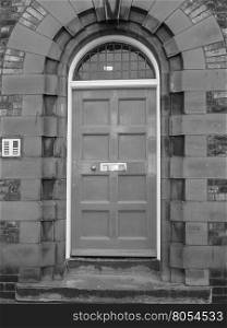 Red British door. Traditional entrance door of a British house in black and white