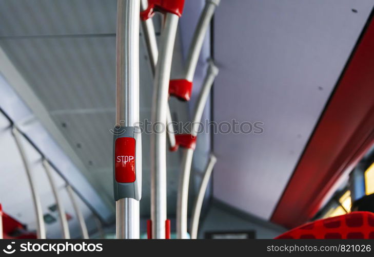 red button to book the stop in a public bus. Public transportation concept