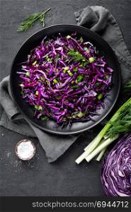 Red cabbage salad with fresh green onion and dill. Vegetarian dish.