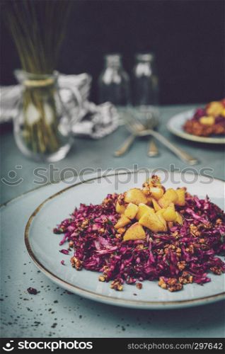 Red cabbage salad with fried apples caramelized with cinnamon for dinner
