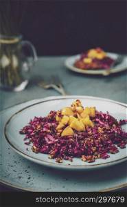 Red cabbage salad with fried apples caramelized with cinnamon for dinner