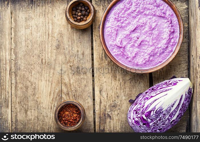 Red cabbage soup on old wooden table.Vegetable soup.Autumn cuisine.. Red cabbage soup