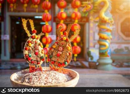 Red candles and burning incense sticks Paper gold with the Chinese alphabet Blessings written on it Is a Fortune blessing compliment for pay respect to god in Chinese New Year day at a Chinese shrine