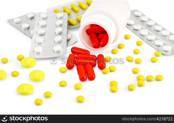 Red capsules in a jar, yellow capsules, tablets are white and yellow isolated on white background