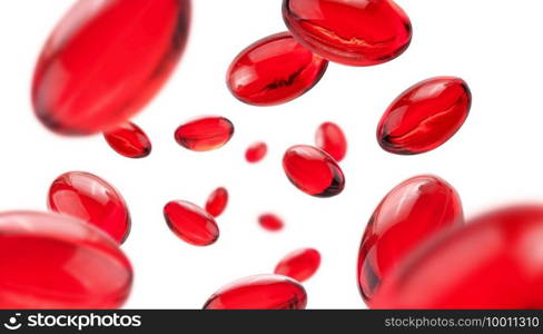 Red capsules levitate on a white background.. Red capsules levitate on a white background