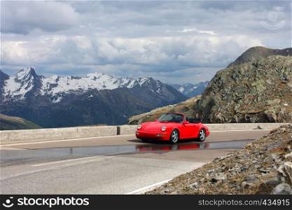 red car at the mountains, italy