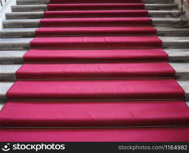 Red carpet on a stairway used to mark the route on ceremonial and formal occasions or events. Red carpet on stair