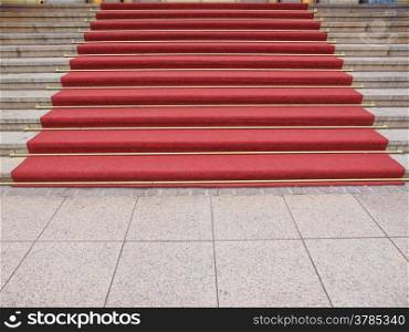 Red carpet. Red carpet on a stairway used to mark the route taken by heads of state, vips and celebrities on ceremonial and formal occasions or events