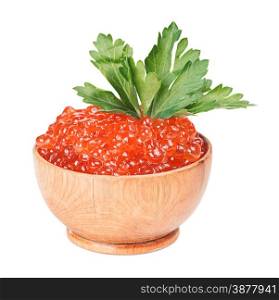 Red caviar in a wooden bowl with parsley leaves closeup isolated at white