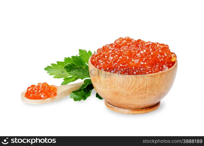 Red caviar in a wooden bowl with parsley leaves isolated at white closeup