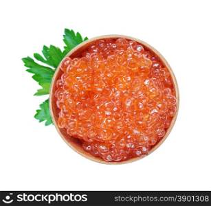 Red caviar in a wooden bowl with parsley leaves isolated at white closeup