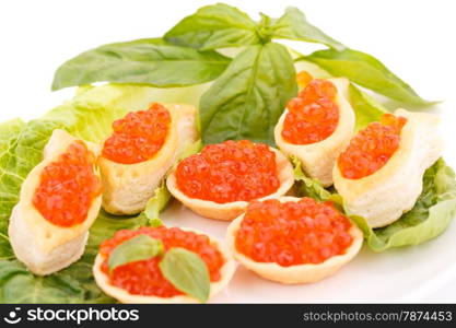 Red caviar in pastries and lettuce on plate.