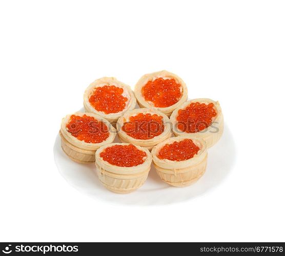 Red caviar in tartlets on plate, isolated on white background, high depth of field, studio shot