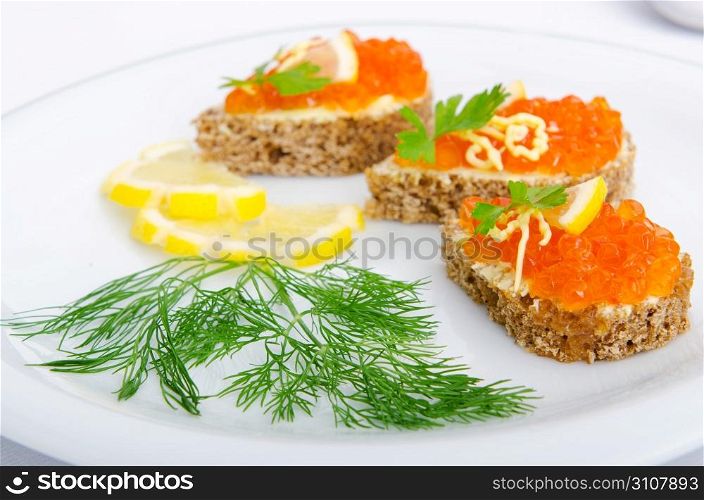 Red caviar served on bread
