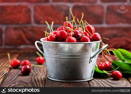 red cherry in bowl and on a table