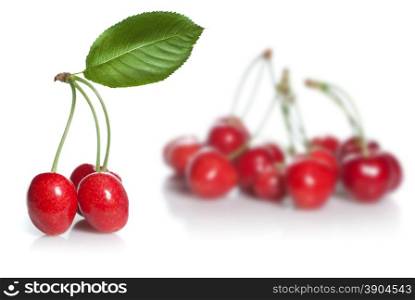 red cherry with leaves isolated on white